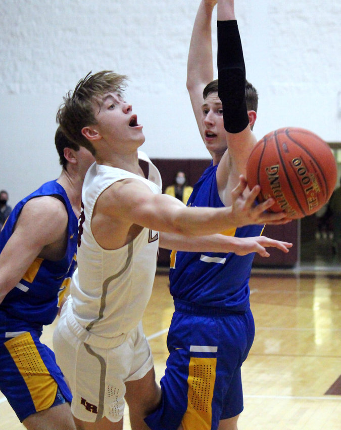 Kanon Gipson pirouettes between two Bolivar defenders to get a shot off in the victory Friday night.