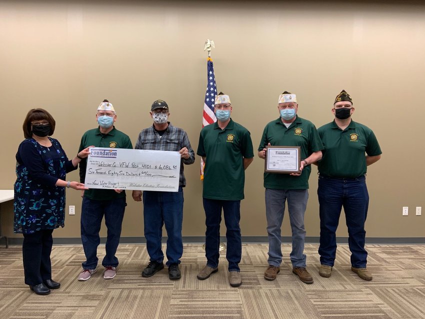 From left, Denise Holdman of the Webster Electric Cooperative presents a grant to the Webster County Veterans of Foreign Wars Post 4101 in Marshfield Thursday night as part of its Operation Round-Up Program. Members of the VFW are Phillip Rippee, Duane Bird, Todd Clark, John Dodson and Matt Kilburn.