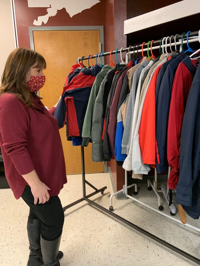 Kristi Taylor, coordinator of the free clothing event, keeps track of the donations in Strafford Middle School Room 21.