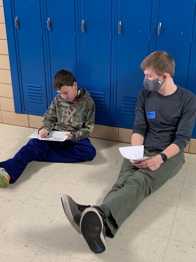 As a mentor in Marshfield High School&rsquo;s A+ Scholarship program, Damon Rust, right, helps students, like Colton Hannaford, left, every day at Webster Elementary School in Marshfield.