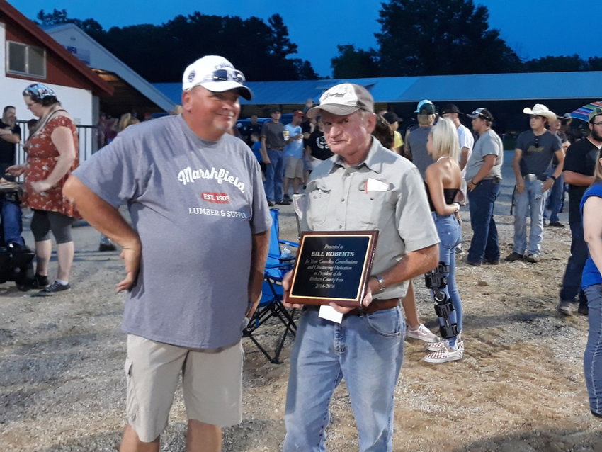 On the last night of the Webster County Fair Saturday, current Fair President Kevin Cantrell, left, presents a token of appreciation to past President and Fair Manager, Bill Roberts, for his four years of service to the county.