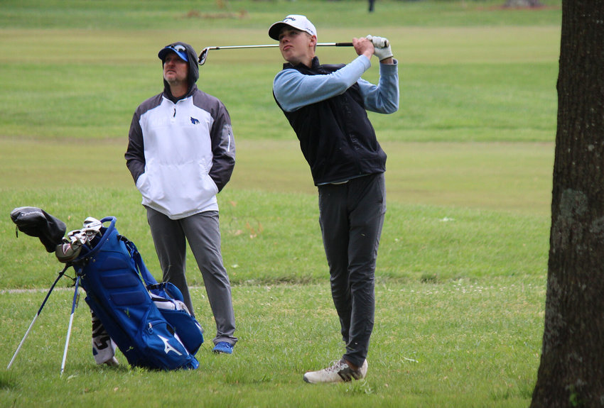 Marshfield coach Reggie Smith watches as Luke Gardner hits a shot at Whispering Oaks Golf Course in Monday&rsquo;s Class 4 District 3 tournament.
