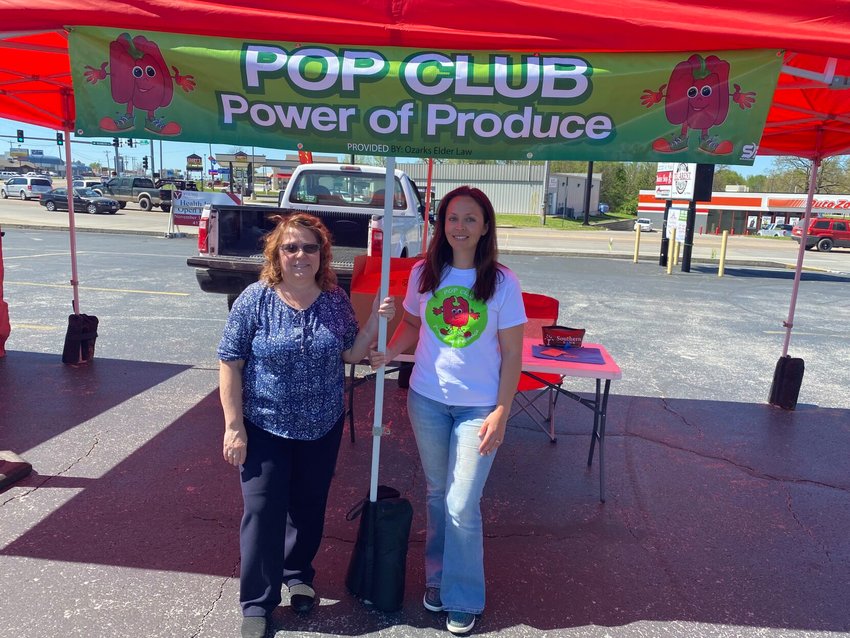 Coordinator Kim Zahn (left) and India Visser (right) man the booth at the POP program tent at the Friday, April 30 Marshfield Farmers Market.&nbsp;