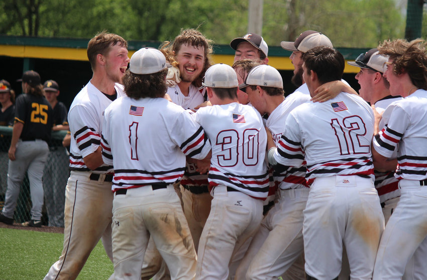 Conway teammates swarm Tanner Simpson following his walk-off home run to beat Pleasant Hope.