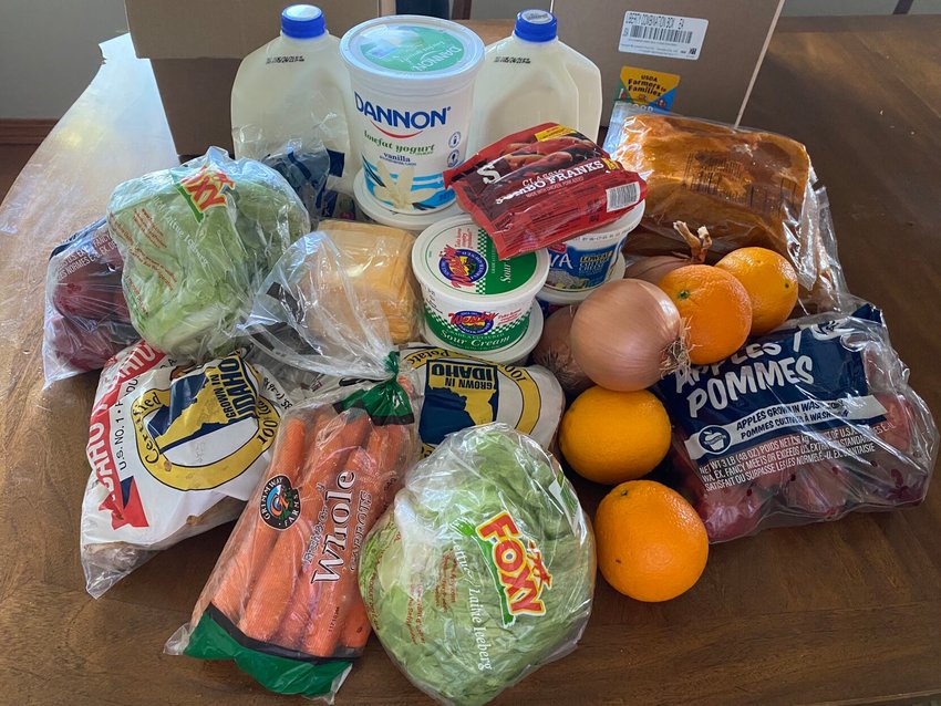 Each Farmers to Families box is filled with fresh produce, dairy and meat for families to prepare. This weeks boxes contained a variety of items including chicken wings, hot dogs, lettuce, potatoes, carrots, apples, yogurt, cottage cheese, milk and American cheese slices.&nbsp;