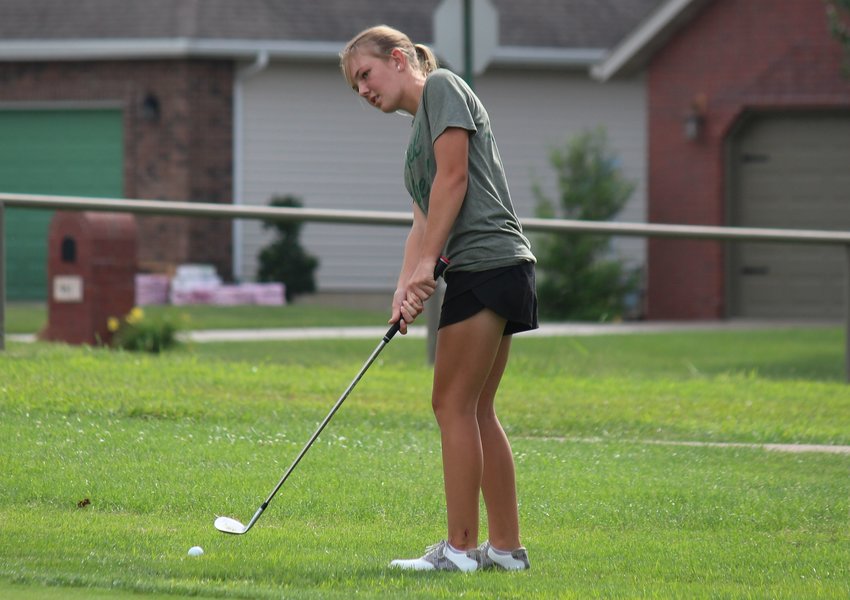 Marshfield sophomore Marlee Edgeman chips onto the green at practice at Whispering Oaks Golf Course, where she shot a 142 as the best score at the course&rsquo;s club championship recently.