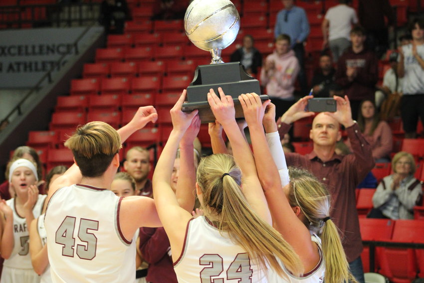 The Lady Indians raise their championship trophy after winning the game against West Plains.