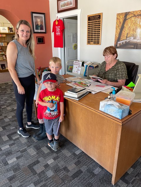 Sheena Crandall and her sons Derrick and Zachary check out books at the Vivian Stuber Memorial Library in Niangua. &ldquo;It&rsquo;s a good way to beat the heat,&rdquo; smiled Crandall as her boys placed their books on the desk.