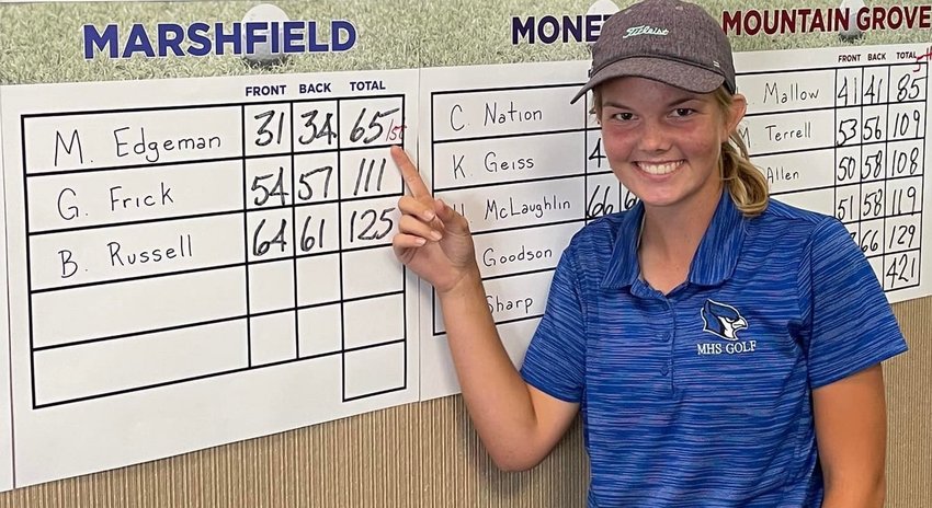 Talk about a hole in one! Marleen Edgeman is seen here next to the scoreboard after she takes first place at Thousand Hills. You can find Edgeman still practicing when she is not in a tournament. &quot;She is self motivated&hellip; she never stops,&quot; tells Marshfield Girl's Golf Coach Cheratin Hunter.