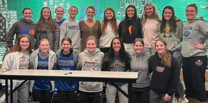 Members of the Marshfield Ladyjays Basketball team stand with SMS Alumni and 2001's WNBA Rookie of the Year Jackie Stiles. Stiles spoke on Monday, Nov. 14 about her own basketball career and the challenges she overcame during it.&nbsp;