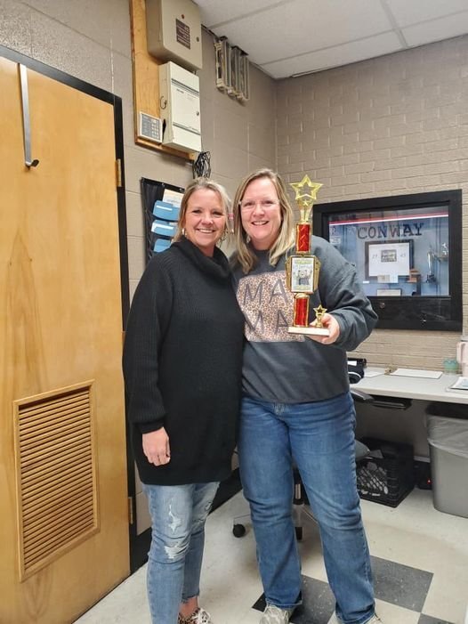 Maryanne Keck presented the &lsquo;Bear Hug&rsquo; Traveling Trophy to admin assistant Cindy Thompson for being &ldquo;the bomb diggity&rdquo; on Jan. 13.