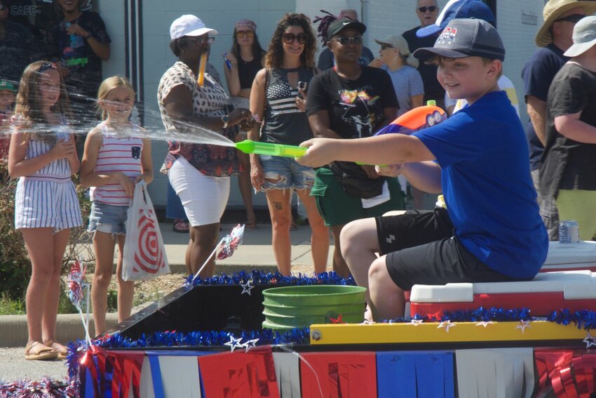 A young Strafford boy cools the crowd off with a water gun.   Mail Photos by Ryder Berger.