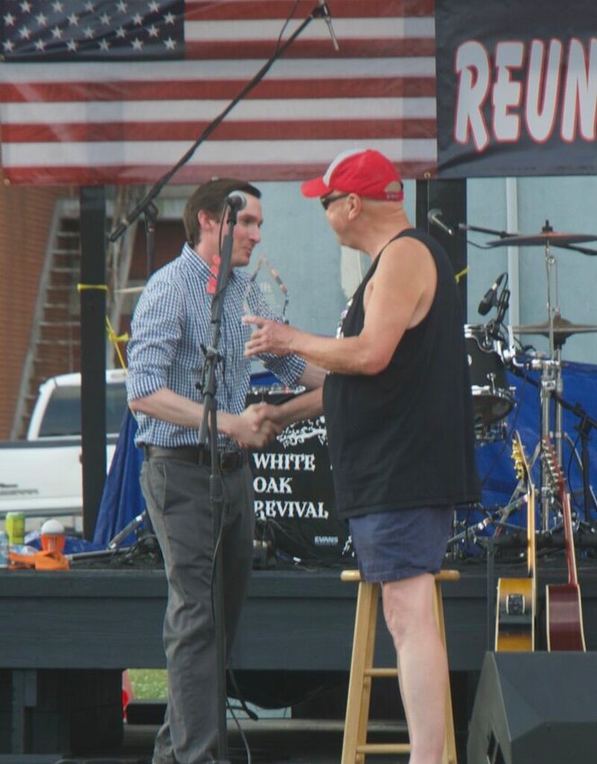 Chad Day greets Mark Eddlemon, former editor of the Marshfield Mail, on stage at Reunion Fest 2023.   Mail Photos by Ryder Berger