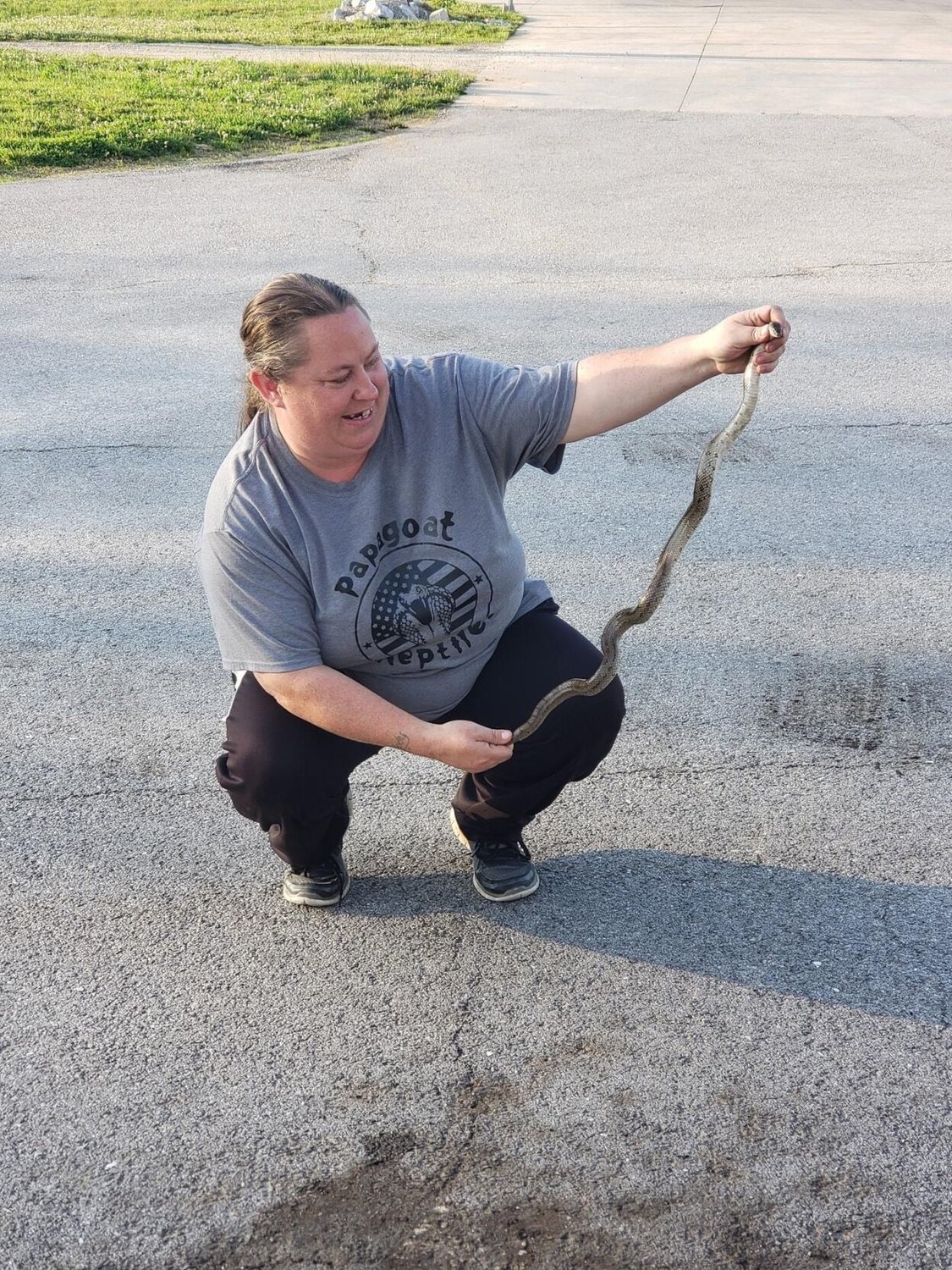 Amanda Fisher poses with the Prairie King snake she rescued from Fordland City Hall last week.