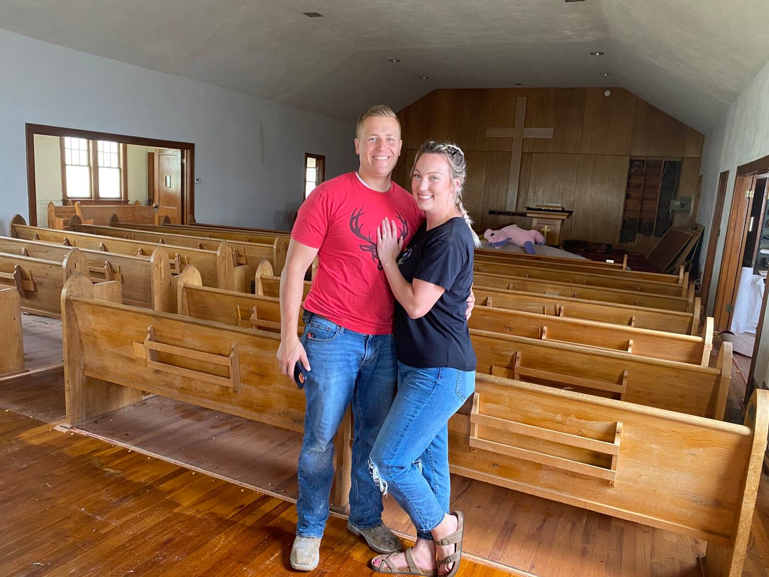 Josh Morley (left) and Danae Wheeler (right) pictured in the sanctuary of their new home.  The couple plans to leave the sanctuary as a sanctuary space which will double as a formal living room. Sharing the upper level of the home will be the kids’ bedrooms and a master bedroom with a bathroom.
