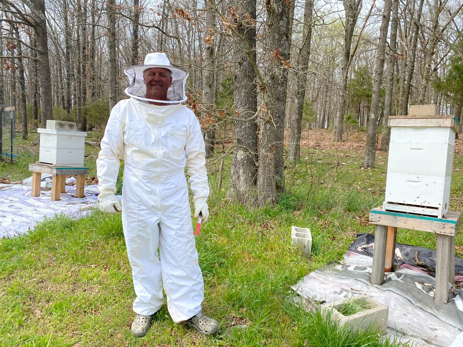 Terry Hardy pictured between his two nucs in his backyard located in Marshfield, Mo.