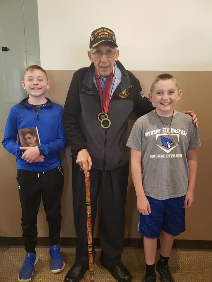 Graziano is the last surviving witness to the German Surrender of World War II, and is a hero to many of all ages. Marshfield students Mason (left) and Blake (right) Lawrence were enthralled by his speech and can’t wait to read their new copies of his memoir.