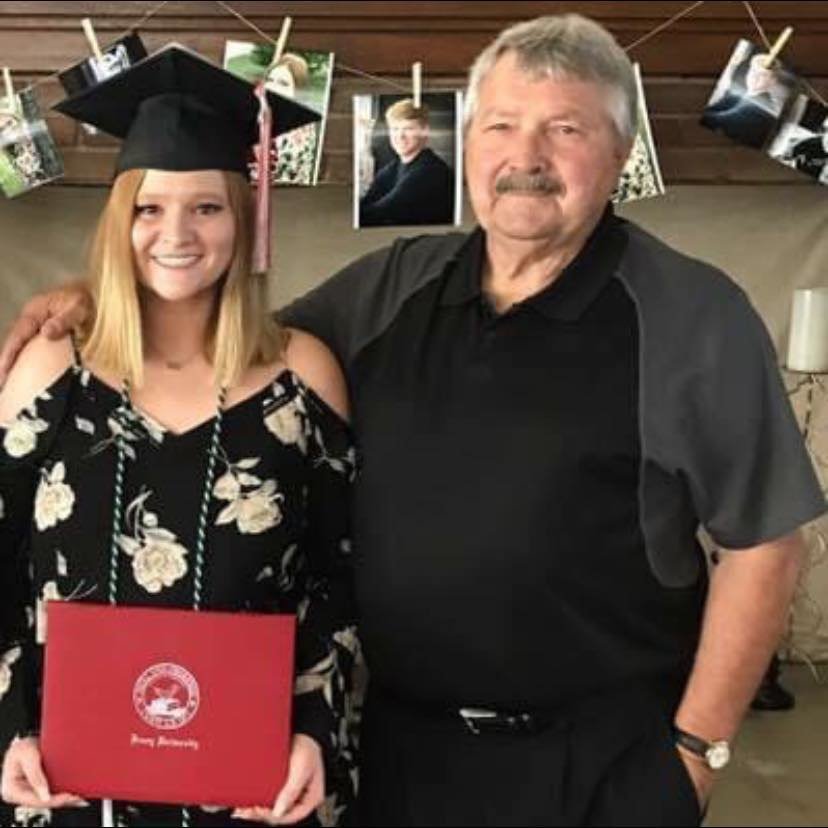 Mail editor Shelby Atkison pictured next to her grandfather, Bob Atkison at her college graduation.