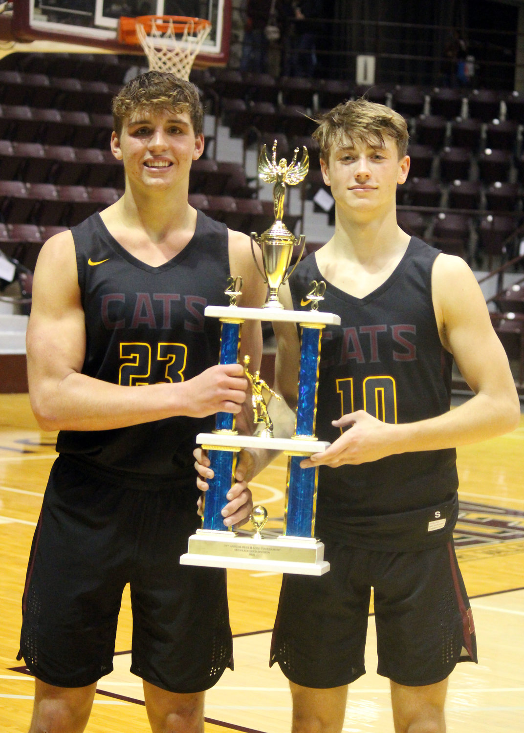 Logan-Rogersville former players, Zach Bergmann (left) and Kanon Gipson together hold the Gold Division third-place trophy following the win over Ozark in the 2020 tournament.
