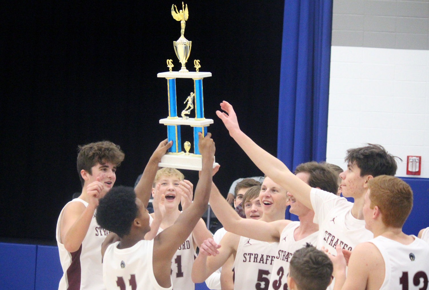 Strafford players lift the fifth-place trophy at Greenwood High School after defeating Bolivar in the 2020 5th place game.