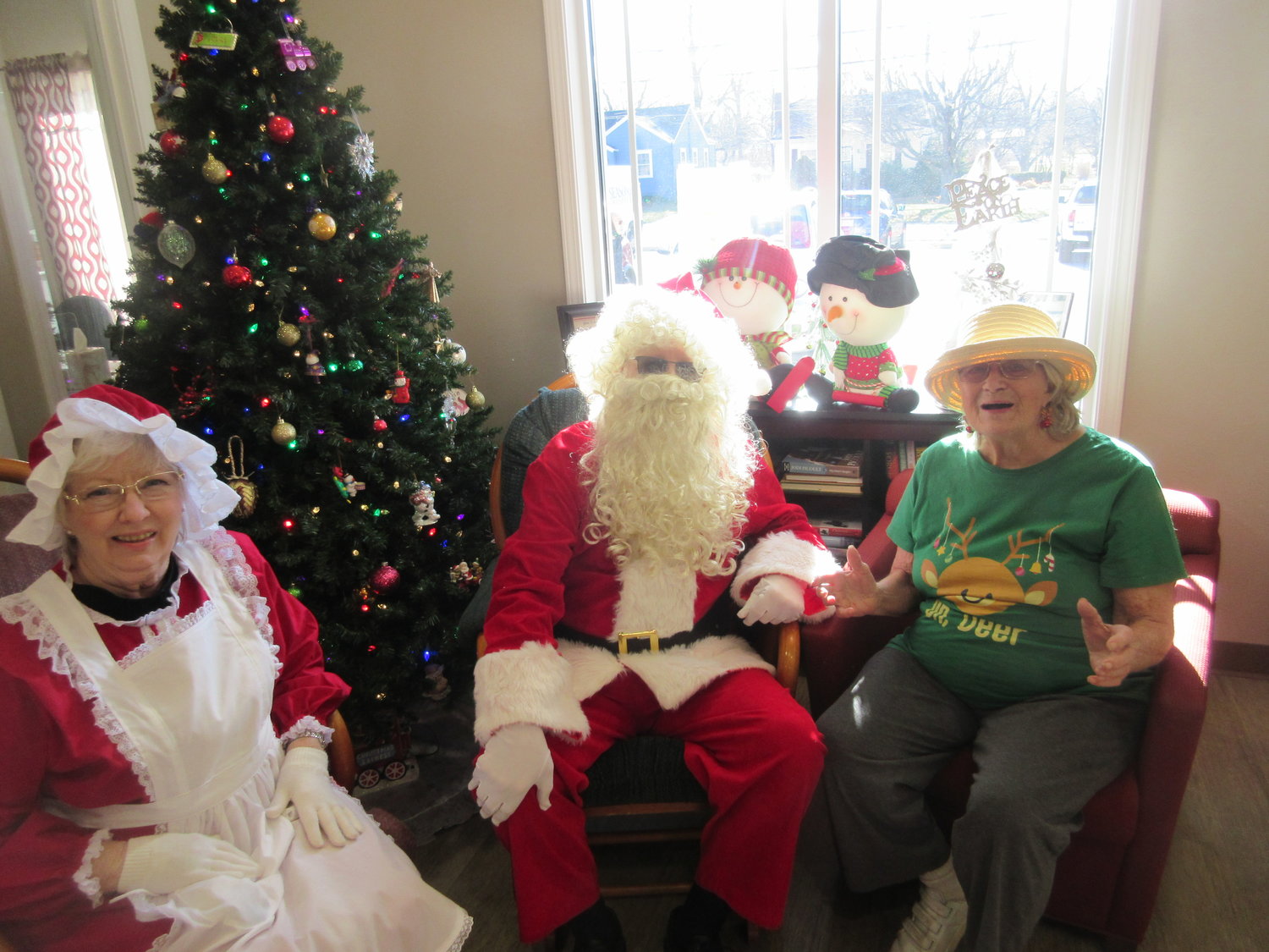 Santa and Mrs. Clause from Seasons Hospice pay a visit to residents at the Marshfield Senior Center ahead of Christmas.