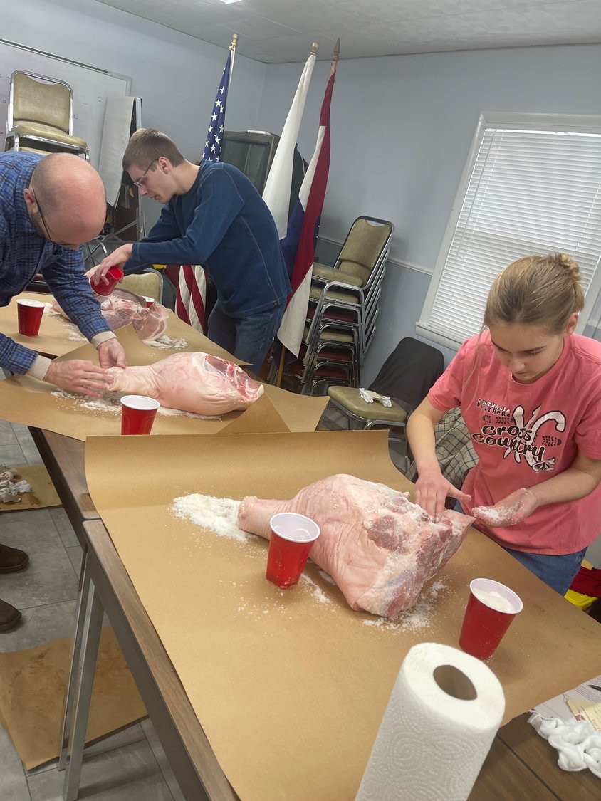 family affair – The Keene family, of marshfield, takes on the country cured ham class at the Webster County Extension Center on Saturday, Jan. 15.