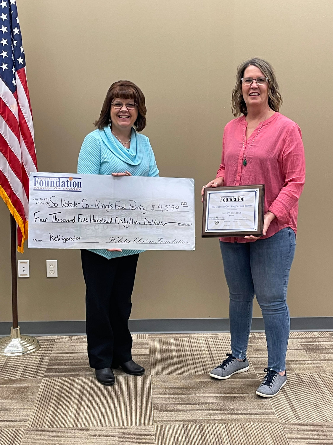 A member of the Southern Webster County Food Pantry DBA King’s Food Pantry accepts the grant award in the amount of $4,599. The organization plans to purchase a large industrial size refrigerator to replace three old models.