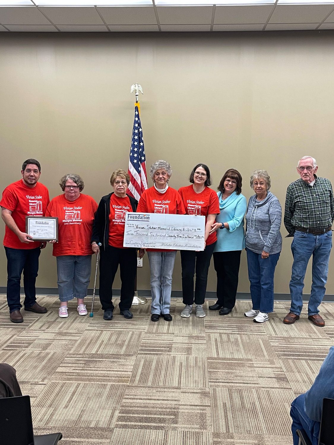 Members of the Vivian Stuber Memorial Library accept a grant in the amount of $3,673. The library has been open in Niangua for 10 years and have plans to purchase gutters for the building, a dehumidifier, new tiling and a book case with the grant funds.
