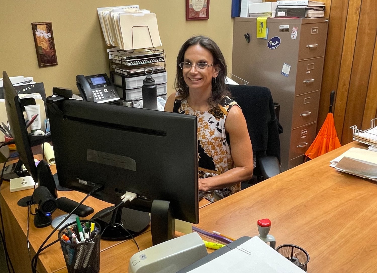 Monica Robinson smiles from behind her desk. Monica’s responsibilities as the Finance Director include report preparation and budget creation for the City of Marshfield.