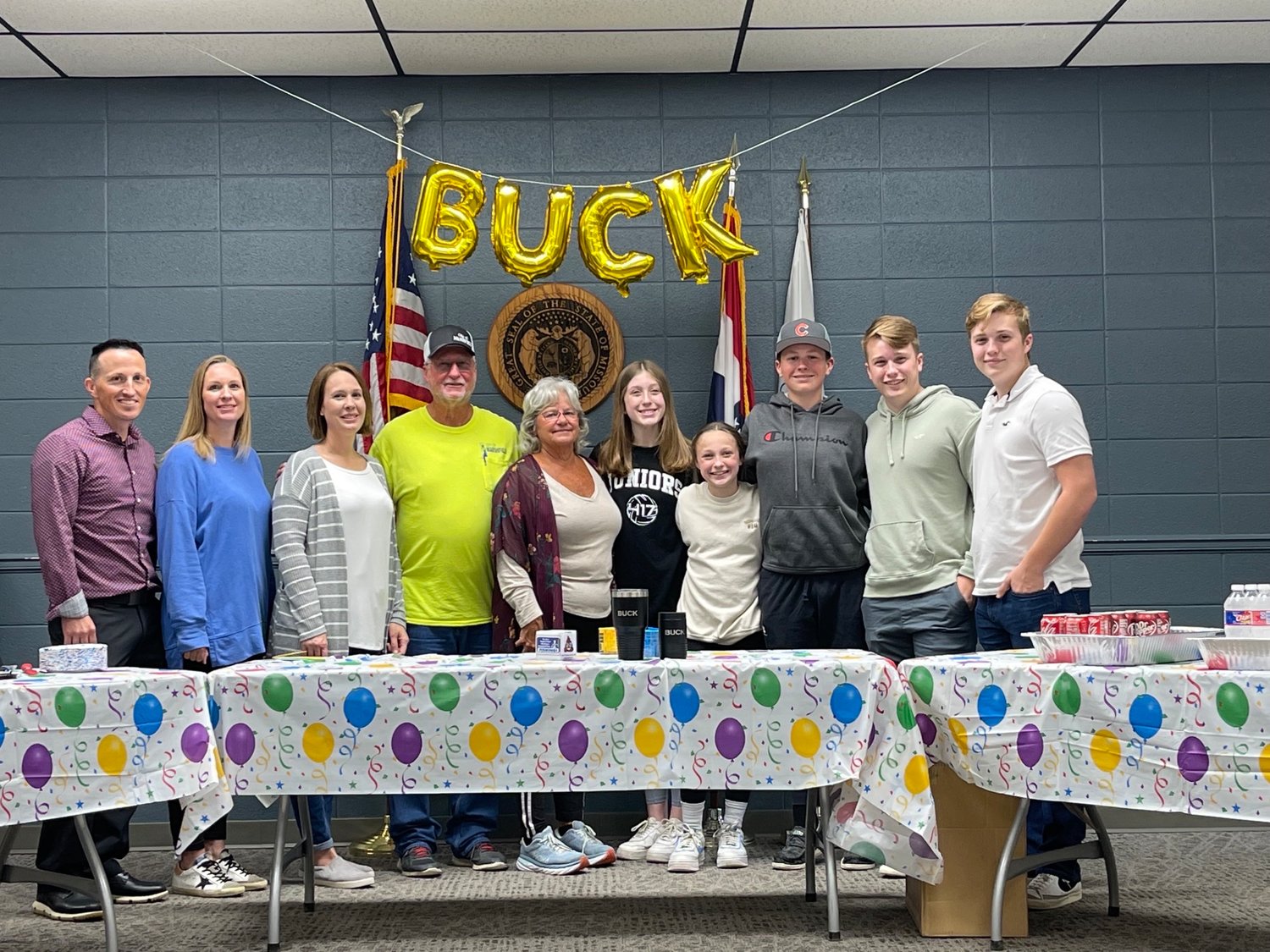 "Buck" in yellow with his family at his retirement party.