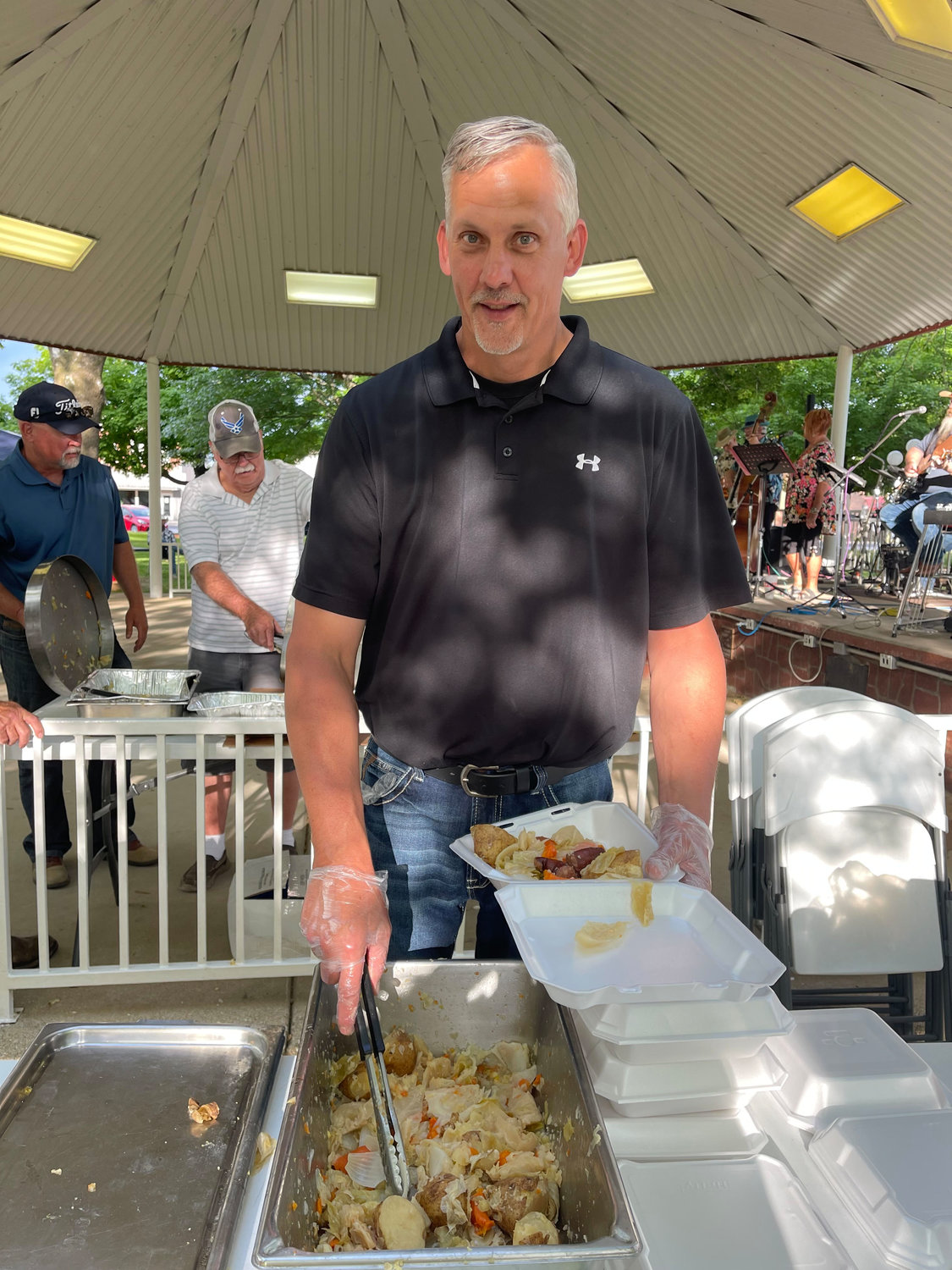 “Guy” serves food to hungry patrons at the Trash Can Feed on June 4 in Seymour. Plates were $10 each and benefited the King’s Food Pantry. 50lbs each of potatoes, carrots, onions and cabbage, along with corn and sausage made up the meal cooked by The Masons.