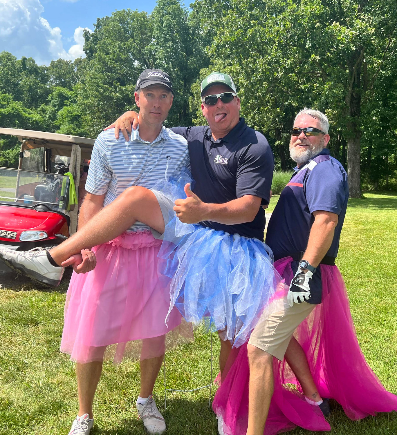 David Coutchie, Chan Crooker and Mark Sammons were all smile and laughs while posing in their skirts.