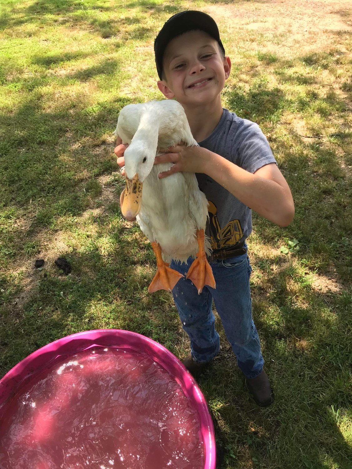 Evan stops from bathing his duck to pose for the camera.