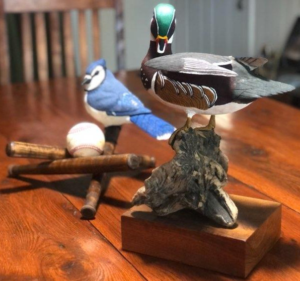 This competition is for the birds… wooden birds that is. The bluejay features a homerun ball hit by one of her sons. The duck shown here is a personal favorite of Lee, painted and carved over several months.