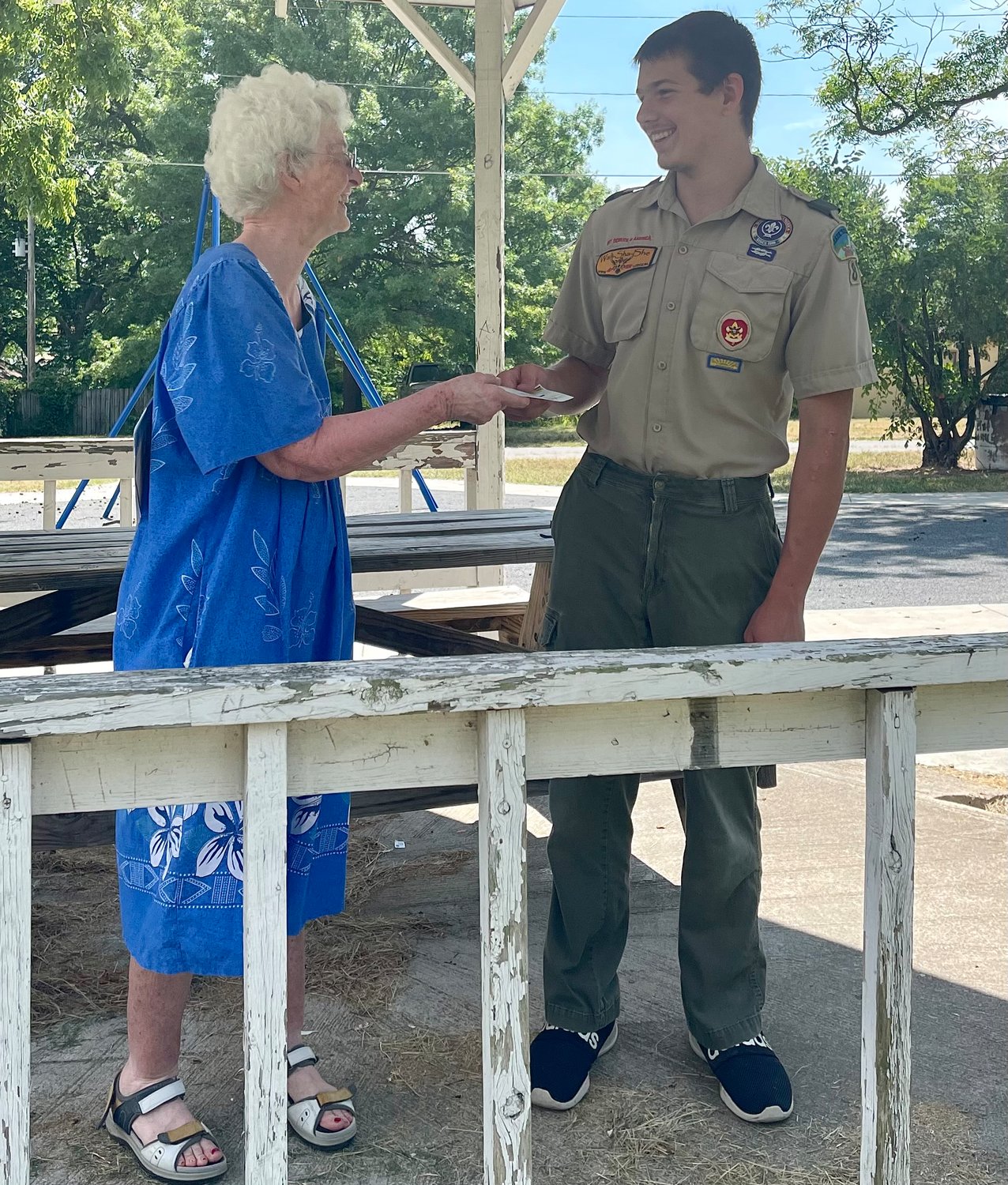 Nora Seery presents Logan with a donation from her son Jim Seery. Jim was the original Boy Scout who built the gazebo at Hartley park thirty years ago.
