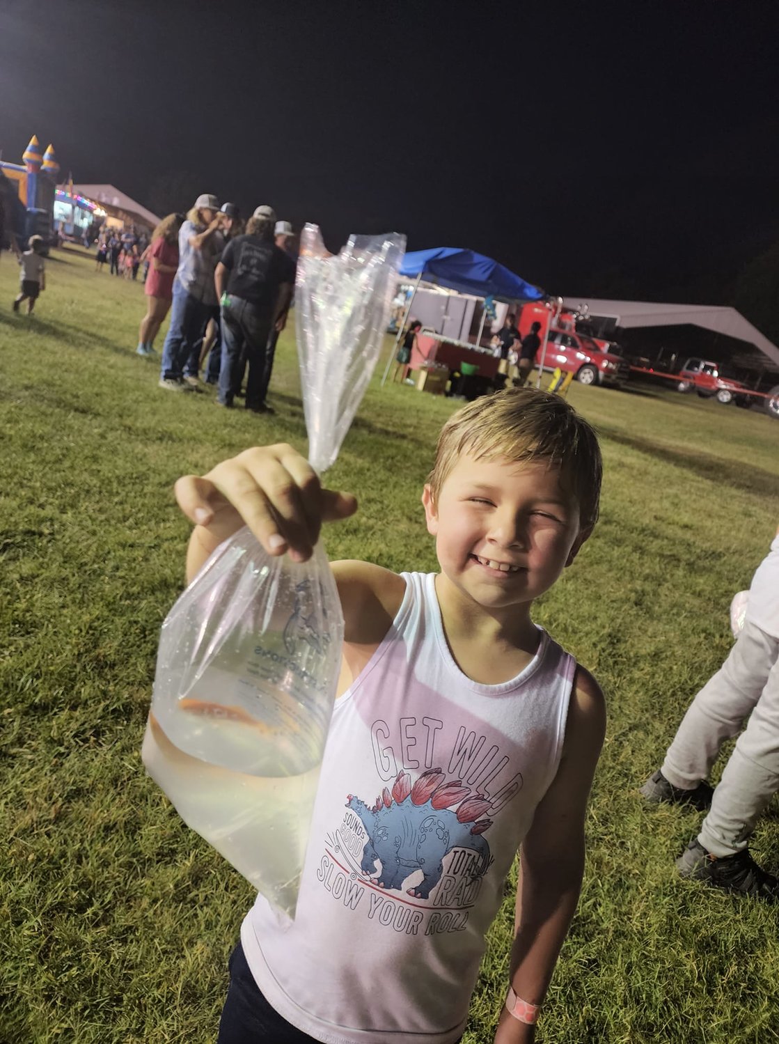 Not all summer fun can be found outside Webster County; Kami Clark and her lil dude had a great time at the tractor pulls this summer, here you can see him showing off the gold fish he won.