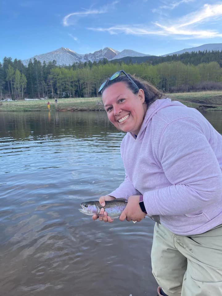 Brandi Thomas and her family hit the road and explored Estes Park Colorado. “We went hiking and we even learned to fly fish,” share Thomas. Pictured is Brandi with her first fish caught on a fly rod.