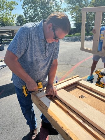 A volunteer is seen assembling a headboard that will then be stained, delivered, and built in the home of a child in need. In addition, volunteers constructed 40 beds on Saturday. This work goes with SHP’s mission, “Make Sure No Kid Sleeps On The Floor In Our Town.”