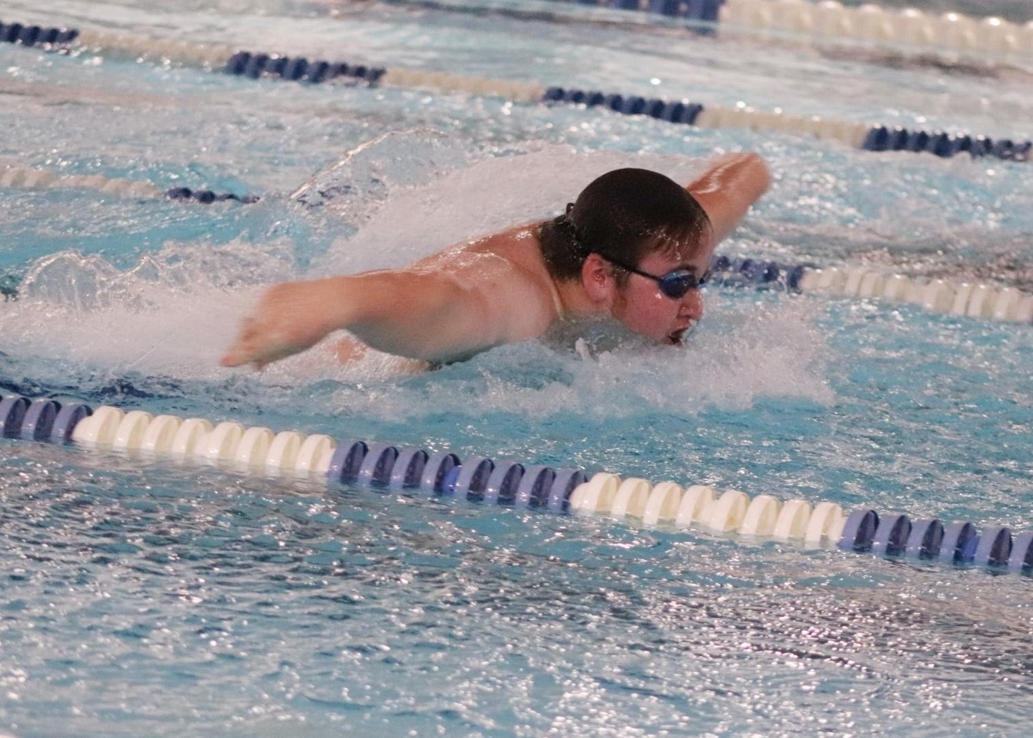 Hayden Davis competes in the 100 Butterfly.