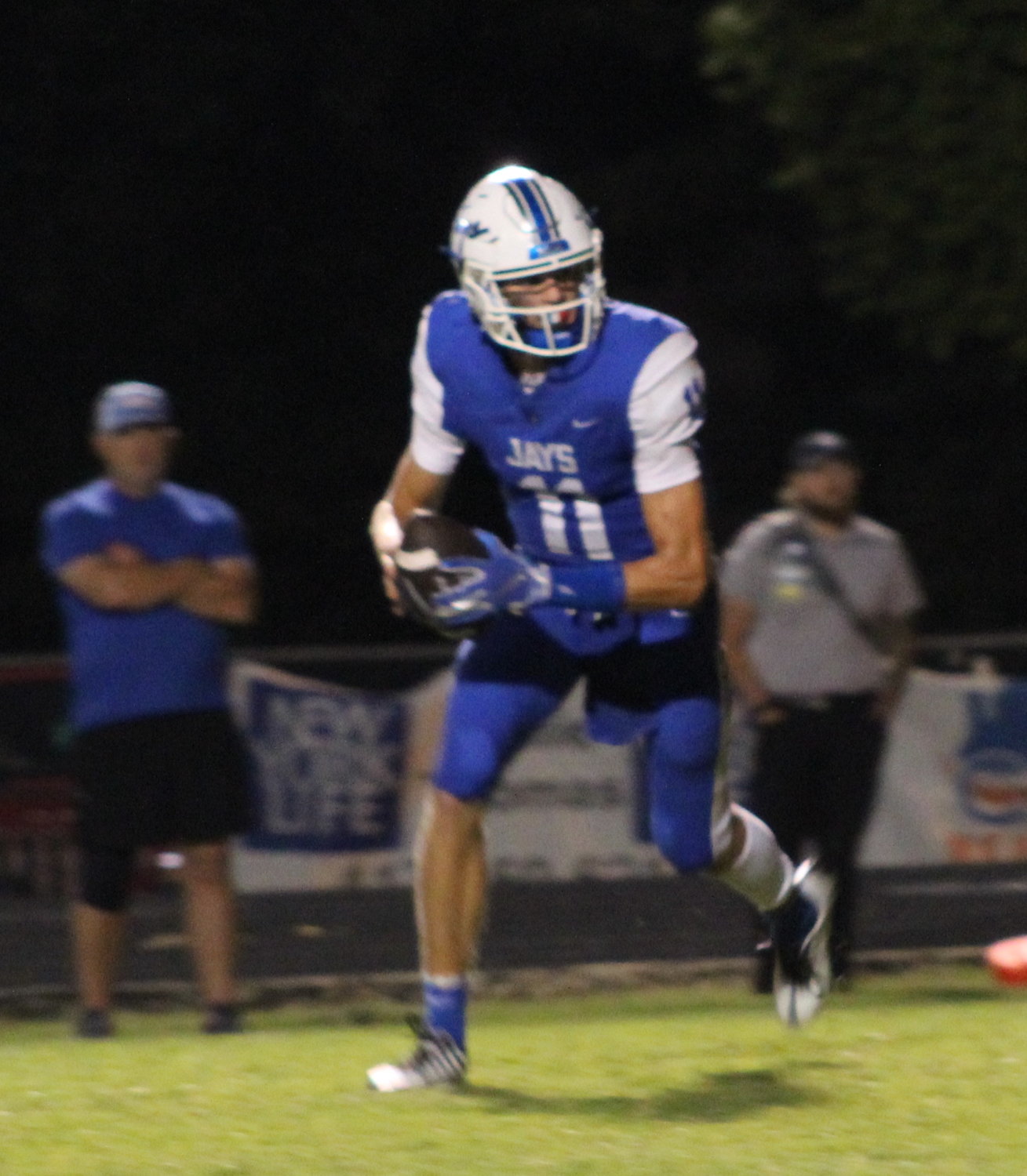 #11 Bryant Bull dashes for room to complete a five yard pass securing the Bluejays their third touchdown of the evening against the Tigers.