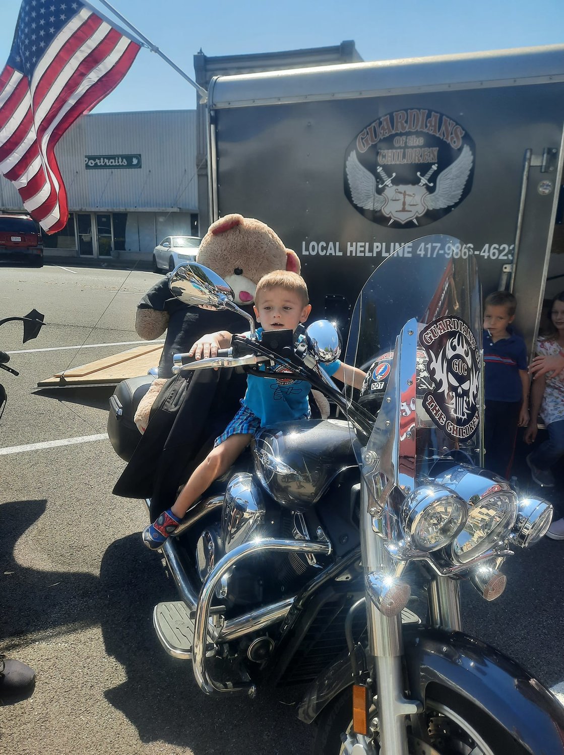 Ryder Venable, age 4, takes a turn on the motorcycle brought by Guardians of the Children.