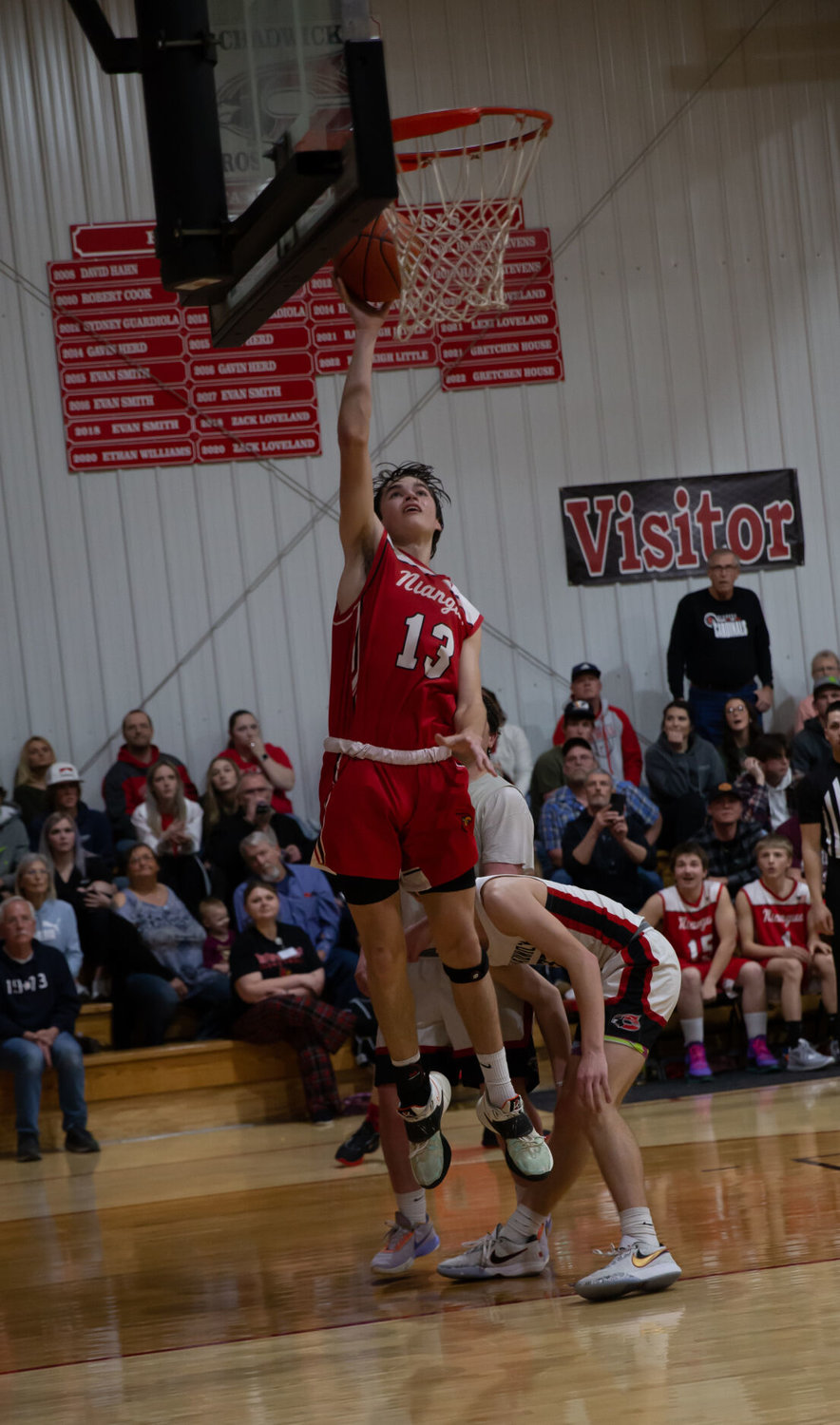 Pictured scoring a basket for the Cardinals is Niangua junior Evan Kochs, who scored 10 points during the match.