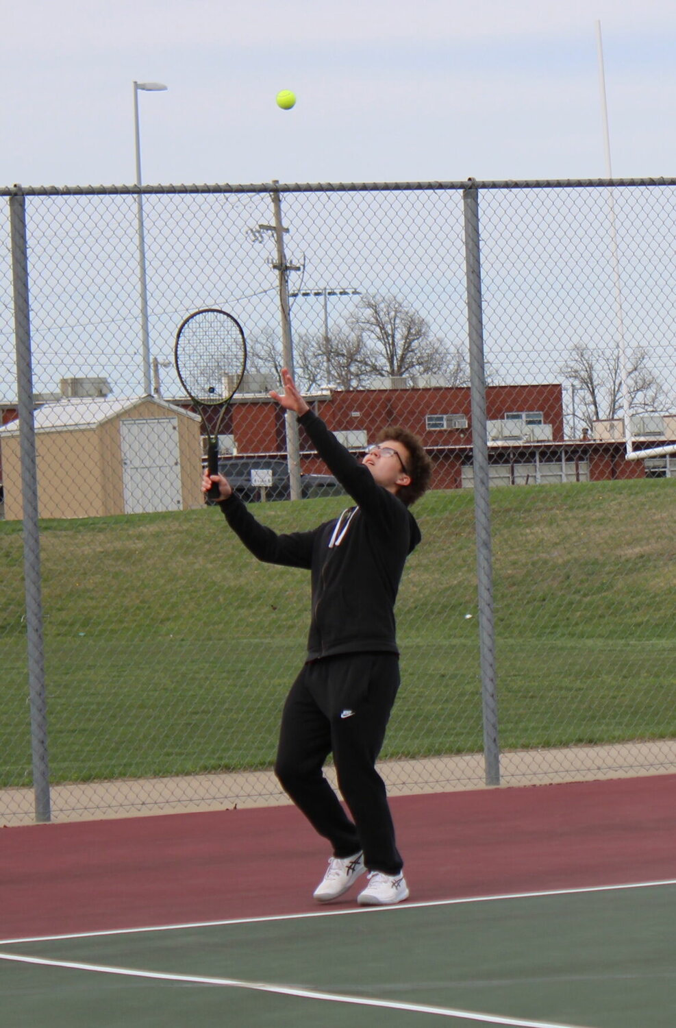 Junior Eli Wachob is pictured as he serves his for his match against Forsyth.


Mail Photos by John "J.T." Jones