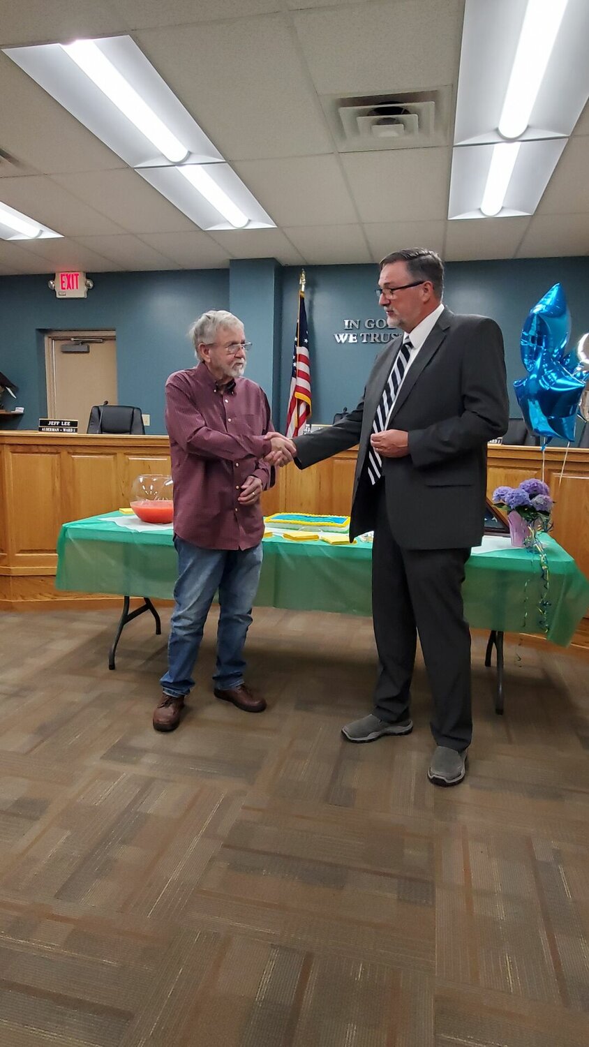 Mayor of Rogersville Jack Cole is pictured congratulating Aldermen Leon Roderick for serving the city with 25 years of public service.