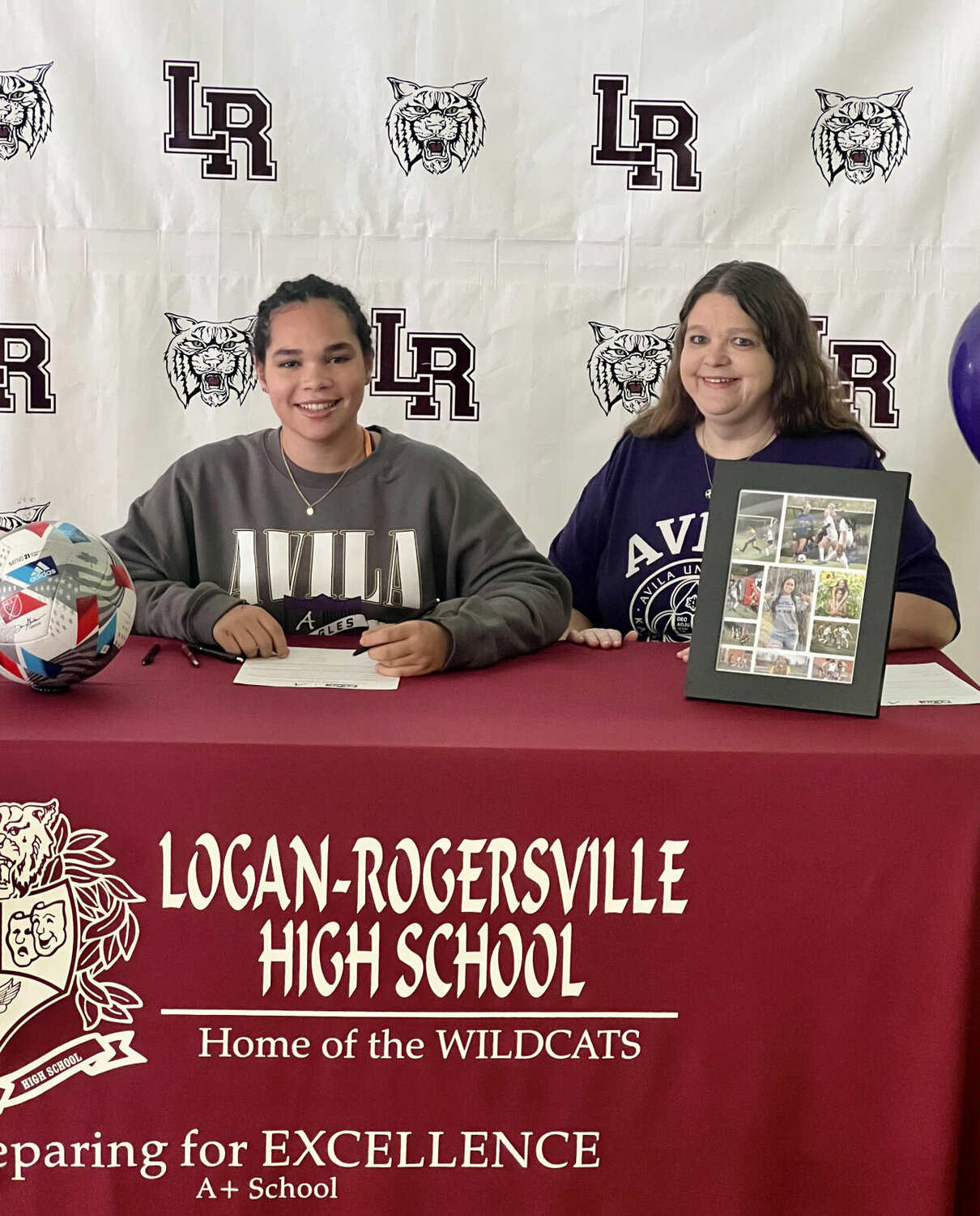 After signing her letter play soccer at Avila University Nikki Wood smiles with pride.