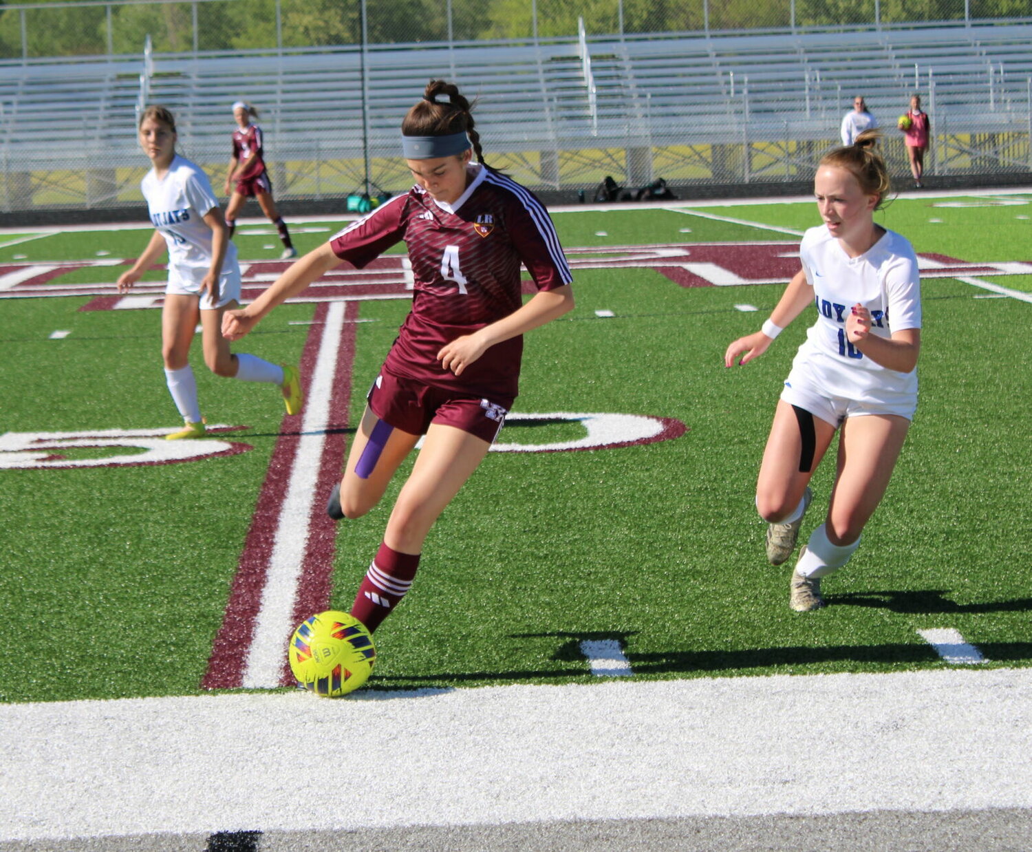 L-R junior Alex Wubbena makes a kick while Marshfield Junior Sydney Strain rushes in, hoping to block during May 2 match pitting the two teams. Wildcats won with a final score of 3-0.