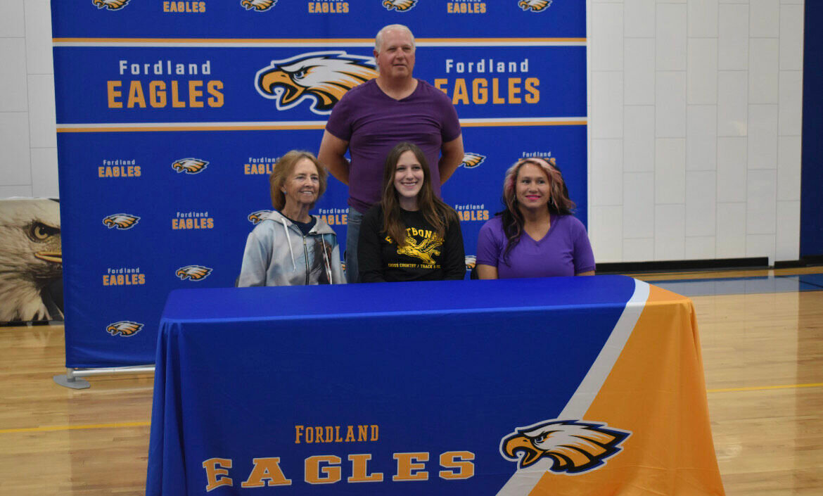 Another senior making a Cross County run to Fontbonne University is Kayce Collins, her family smiling with pride after signing her letter.