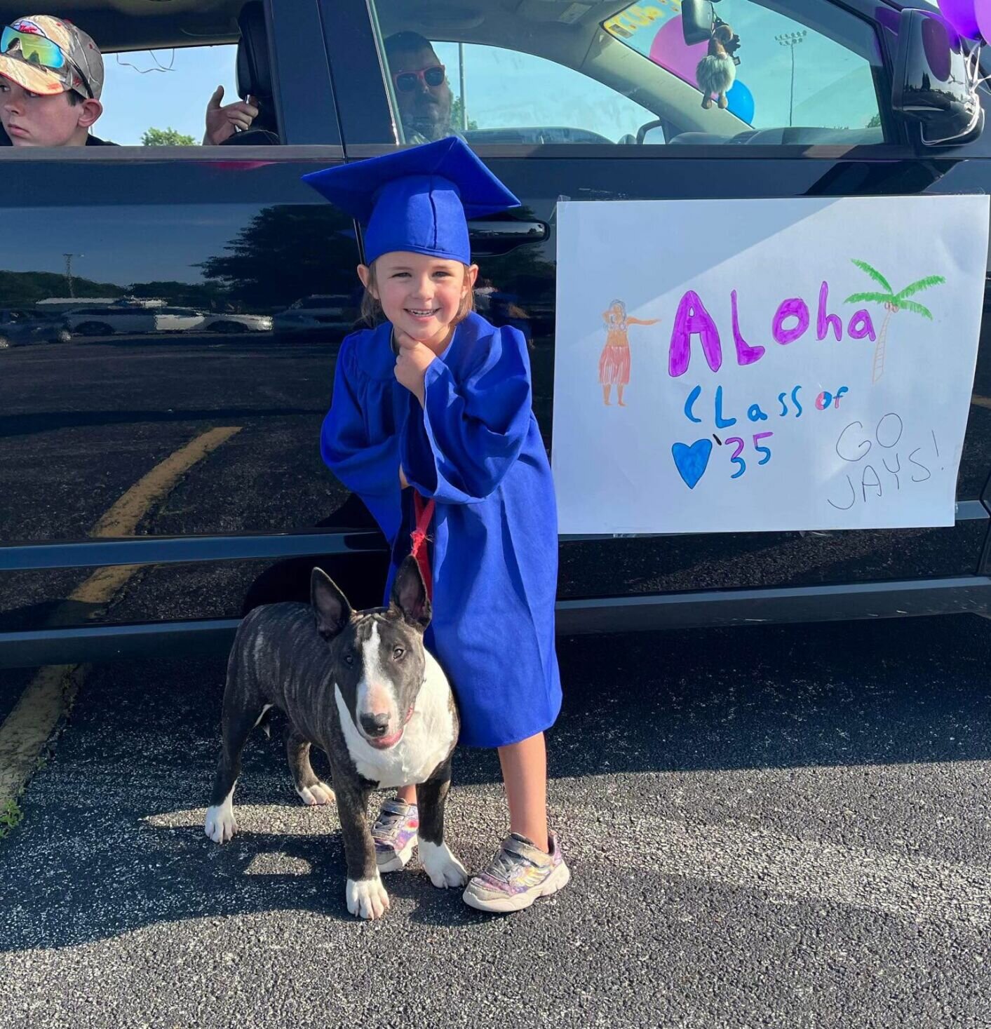 Aloha, Class of '35! This sweet Hubble kindergarten grad poses for a photo with her pup ahead of the parade. 