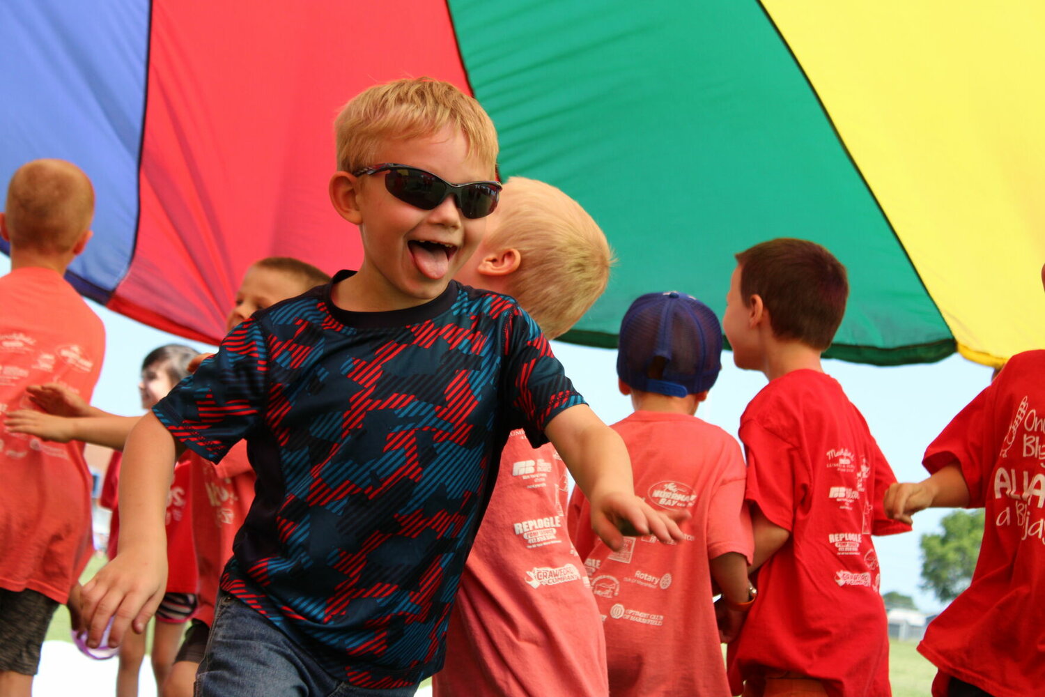 Shades on and smiling! A long-time favorite of Field Day is the rainbow parachute exercises led by Coach Athena Neptune.