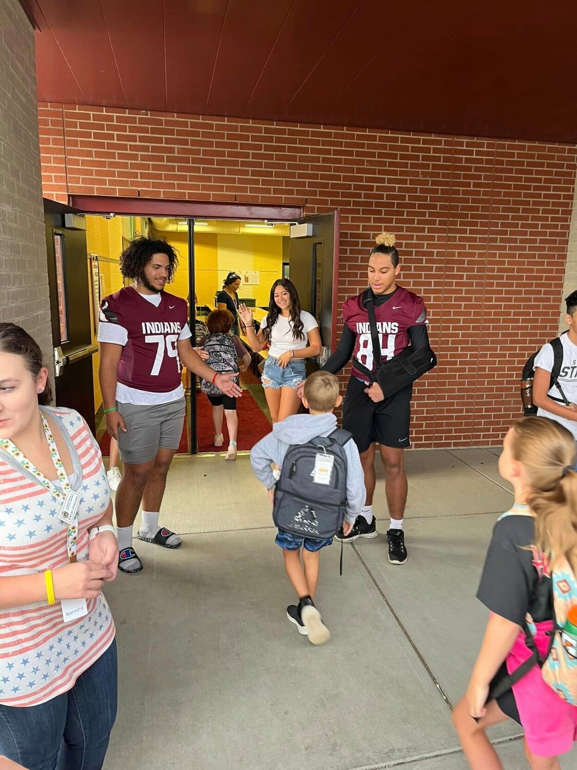 The Indians started game day off right by greeting elementary and middle school students before school on Sept. 9. Seniors JD Adams IV and Amren King are pictured slapping fives to students as they came into school. 